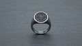 Oxidised silver signet ring for men on a slate grey background