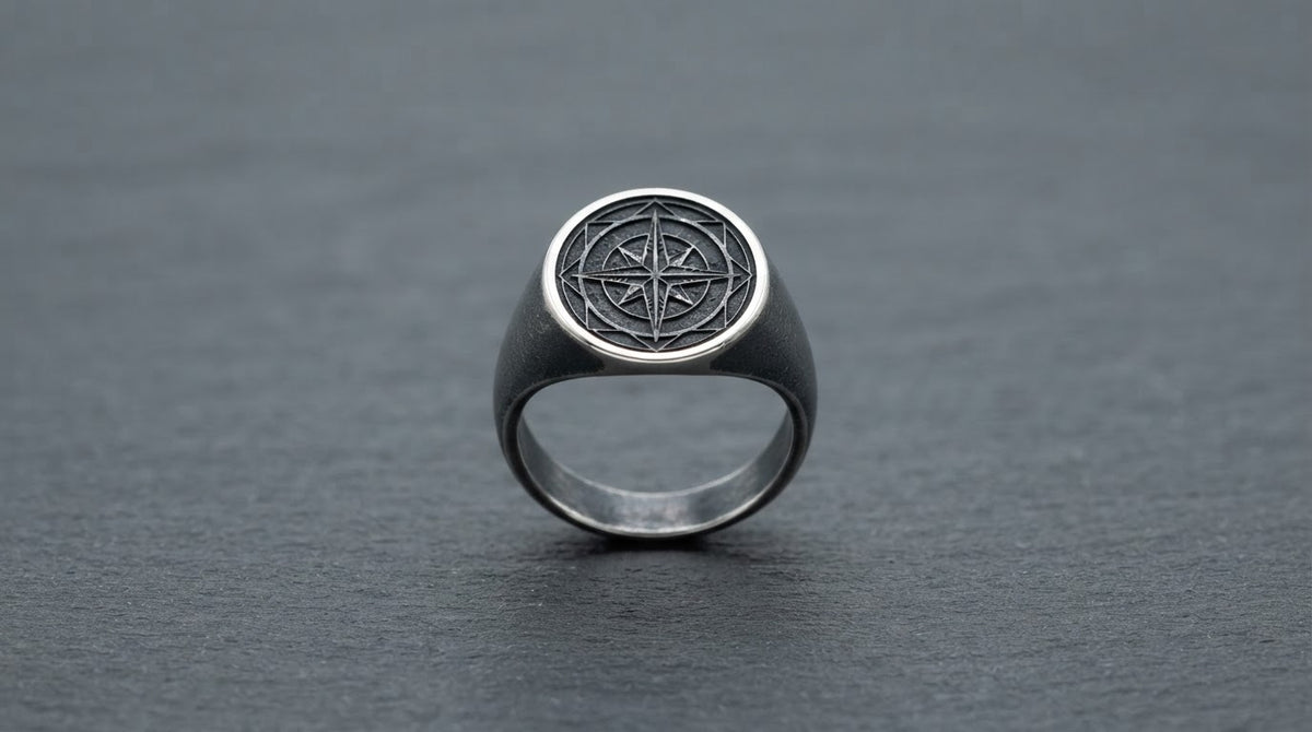 Oxidised silver signet ring for men on a slate grey background