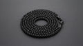 Matte black steel box chain necklace for men on a charcoal background
