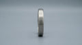 Brushed stainless steel kada for men on a cool grey background