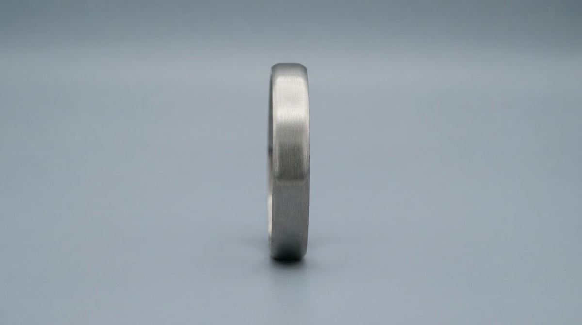 Brushed stainless steel kada for men on a cool grey background